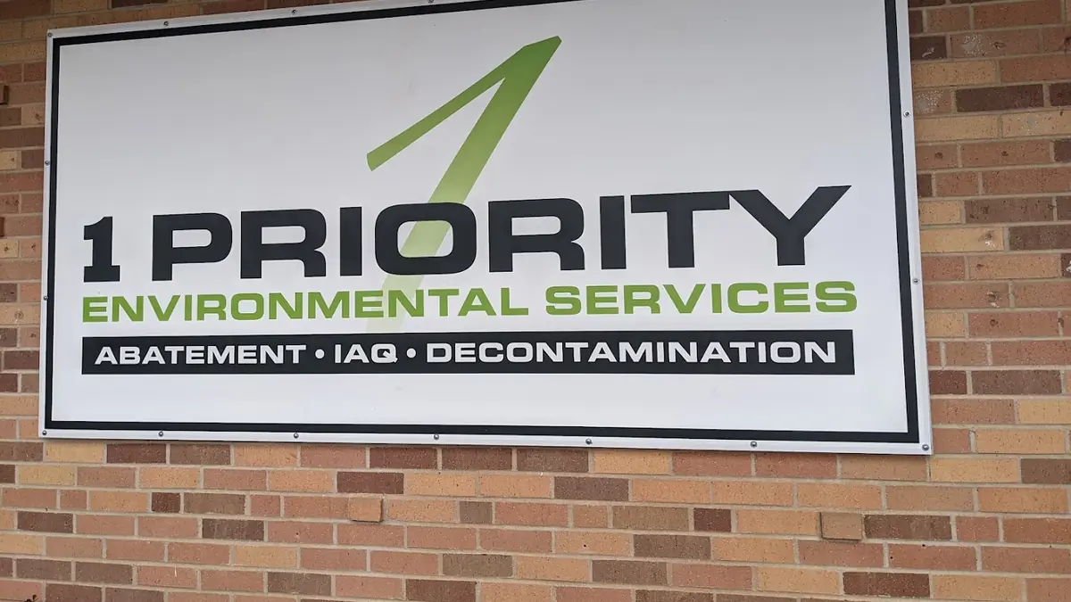 1 Priority Environmental Services - An EIS Company sign mounted on a brick wall