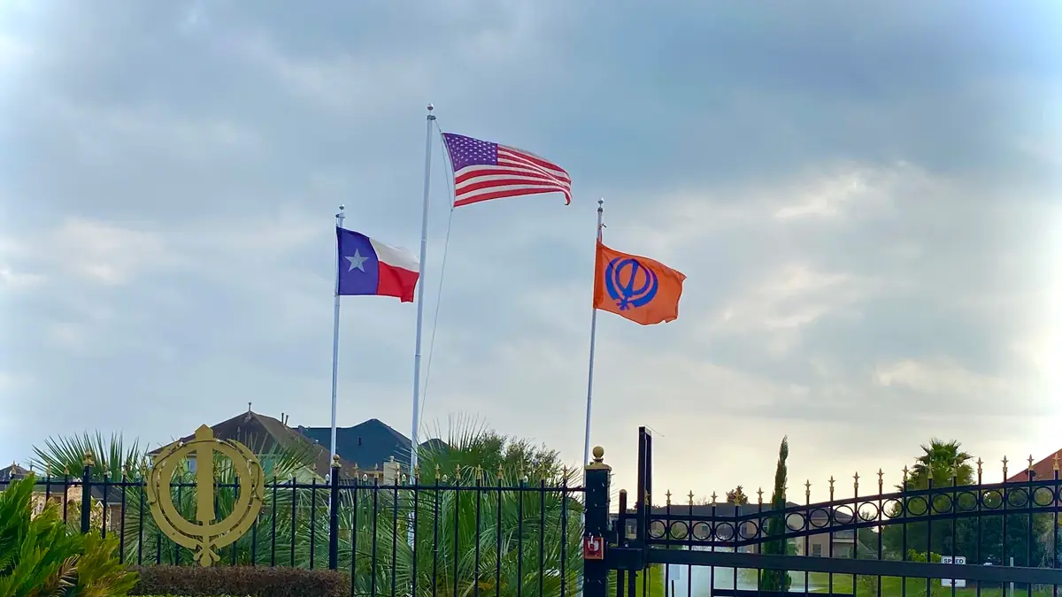 Flags flying at the entrance to a commercial facility