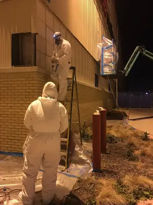 Worker in a protective suit at night
