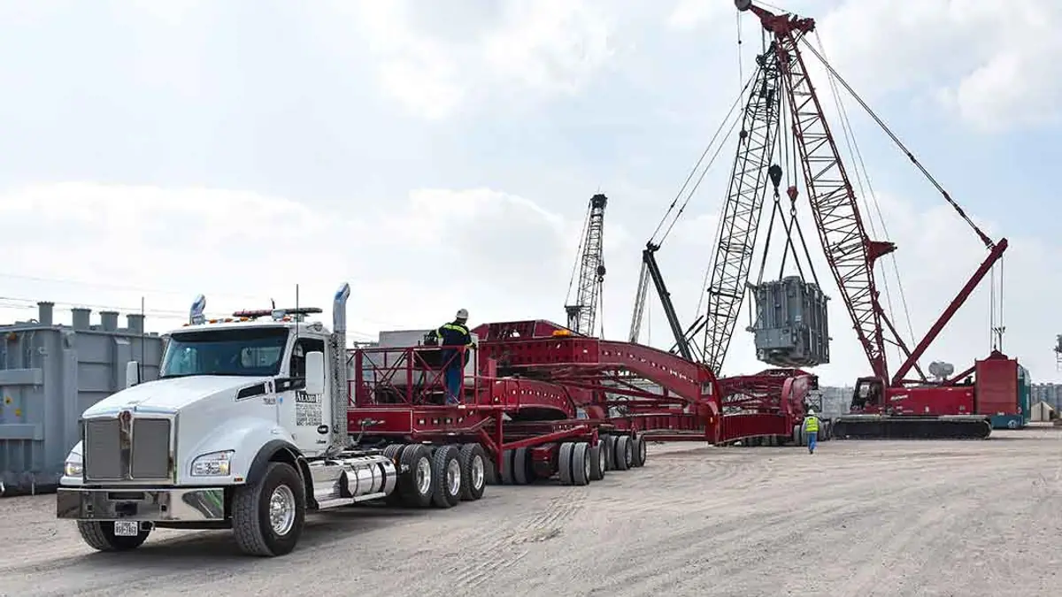 Heavy haul truck and crane on a work site