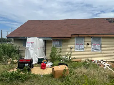 House with equipment outside during remediation