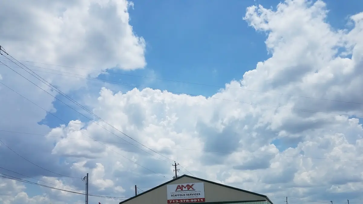 Metal warehouse building under a cloudy sky
