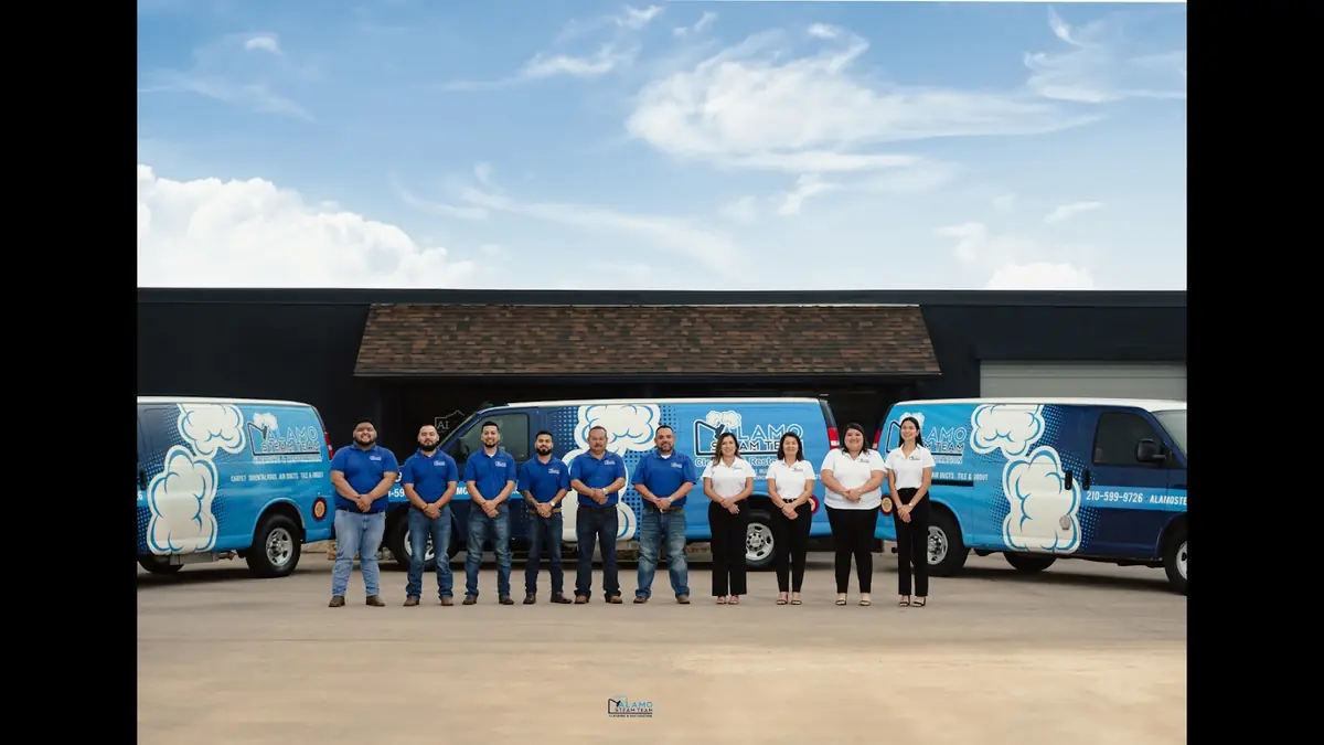 The AST Cleaning & Restoration team with branded vans
