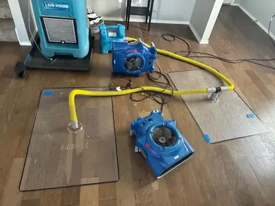 Air movers drying a floor