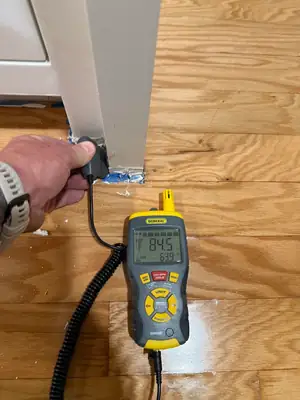 Moisture meter on a wood floor