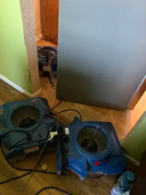 Air movers drying a floor