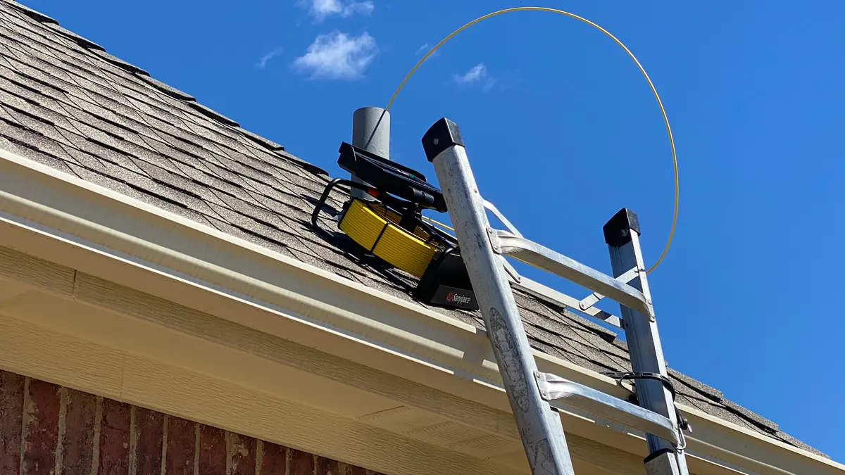 Ladder against a roof edge during a home inspection