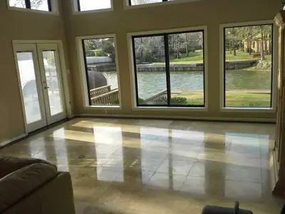 Large room with a wet floor after water intrusion