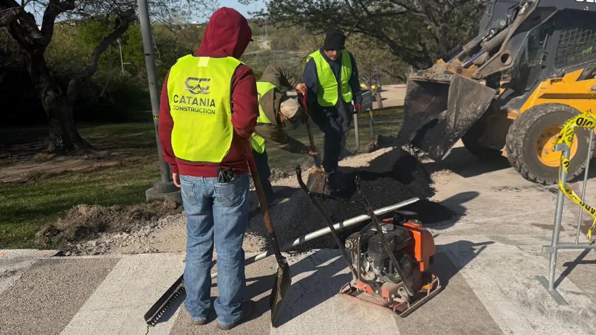 Crew member in a safety vest working on a site