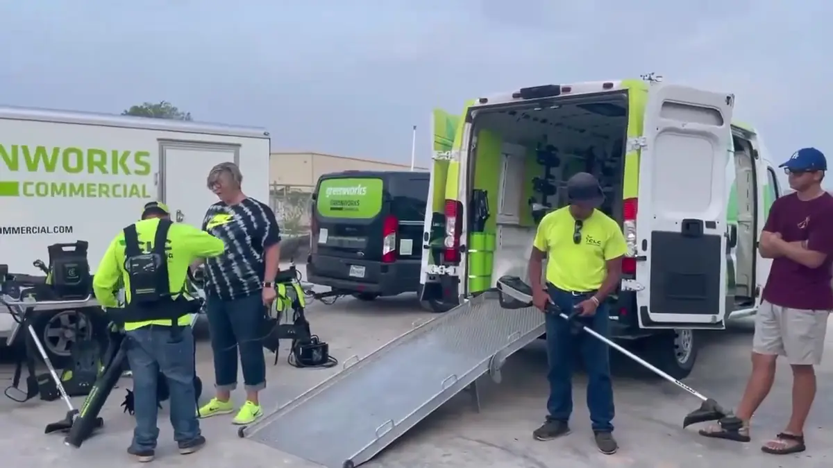 CLC Landscaping, LLC crew in high-visibility shirts with company trucks