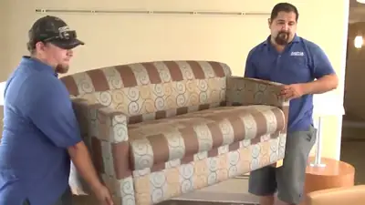 Technicians moving a sofa