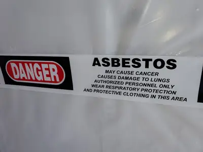 Asbestos danger sign posted on containment sheeting