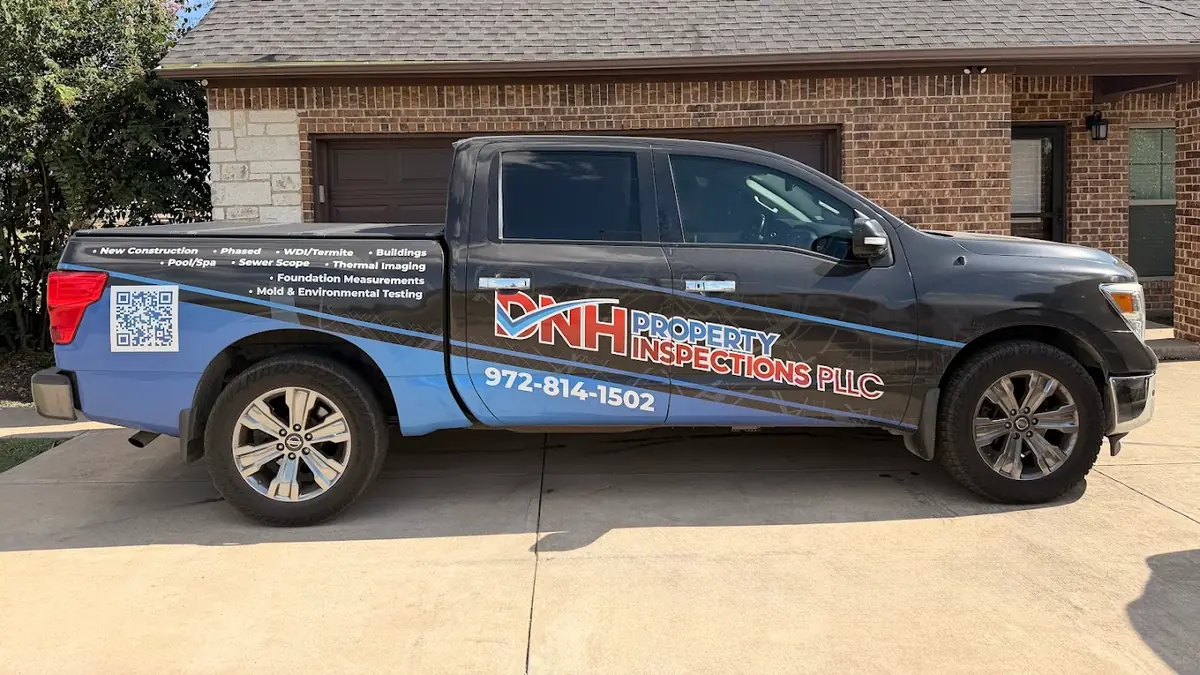 DNH Property Inspections branded pickup truck outside a home