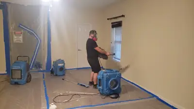 Technician setting up drying equipment