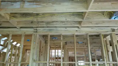 Exposed wall framing after damaged drywall was removed
