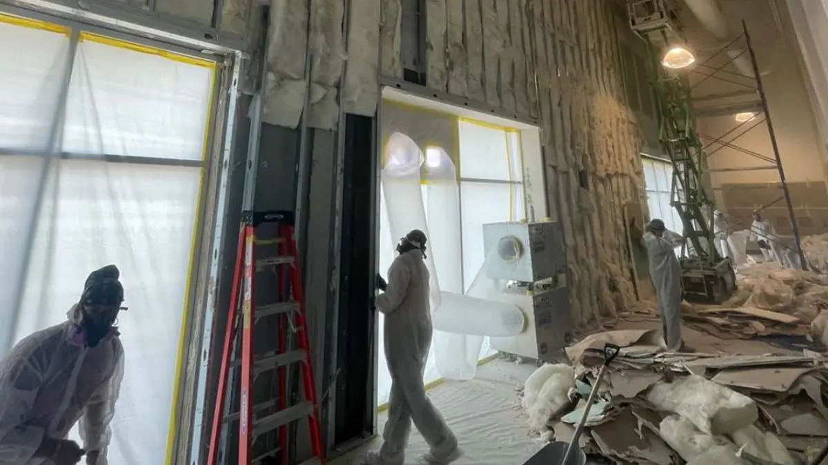 Crew stripping a room back to the studs
