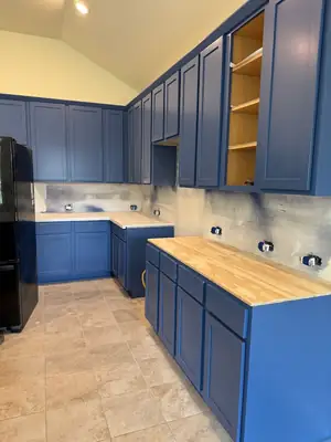 Rebuilt kitchen with blue cabinets