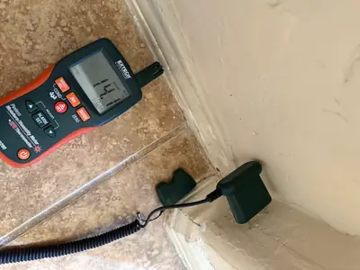 Moisture meter with probe on a floor