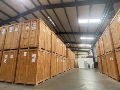 Warehouse aisle lined with wooden storage crates