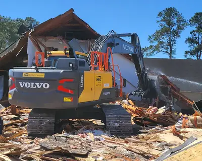 Excavator on a pile of debris