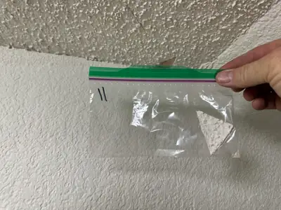 Sample bag held against a textured ceiling