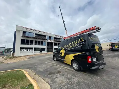 Gold Eagle Services branded van outside a commercial building