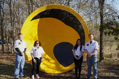 Staff at the Gold Eagle Services sign