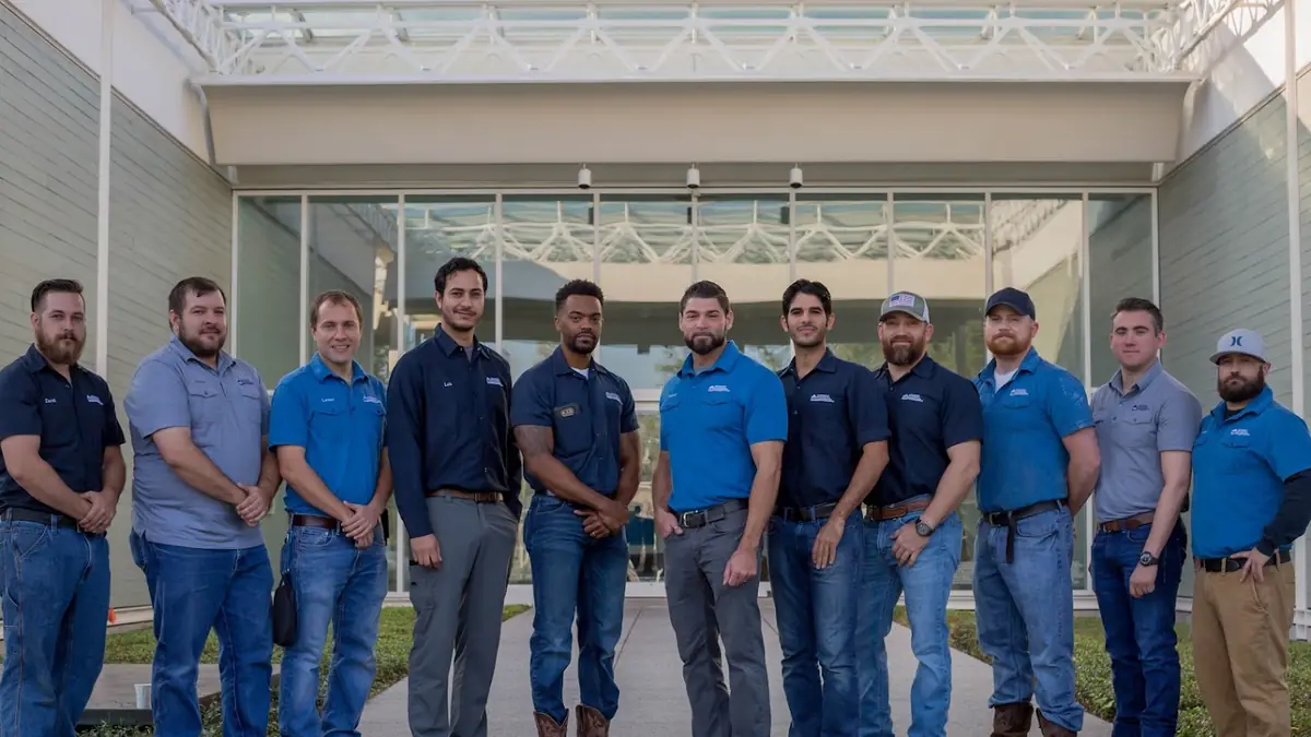 The Hedderman Services team in matching blue shirts outside an office