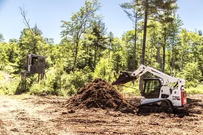Skid steer clearing a lot