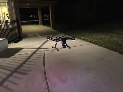 Inspection drone on a driveway at night