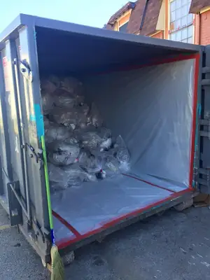 Dumpster loaded with demolition debris