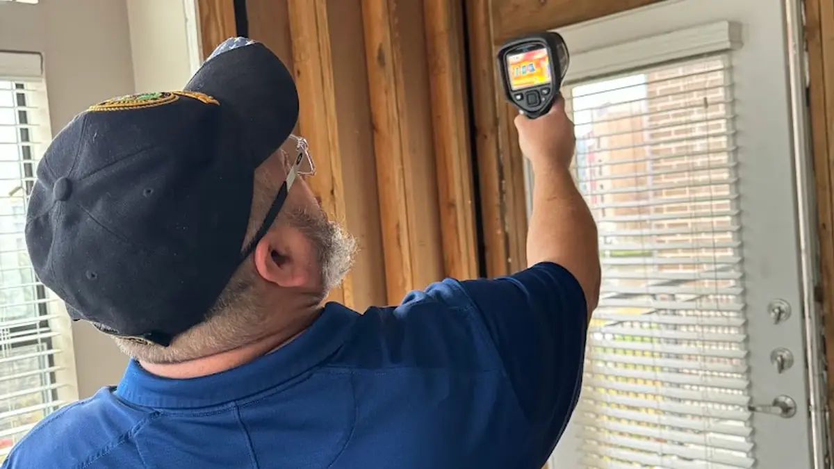 Technician inspecting a window frame