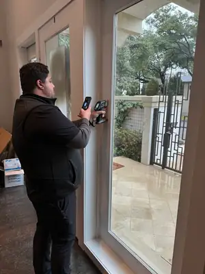 Technician checking a window with a moisture meter