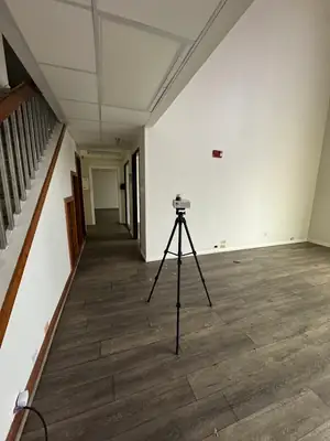 Air sampling pump on a tripod in a hallway