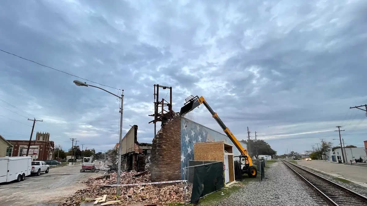 Excavator demolishing a building