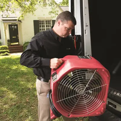 Technician carrying an air mover