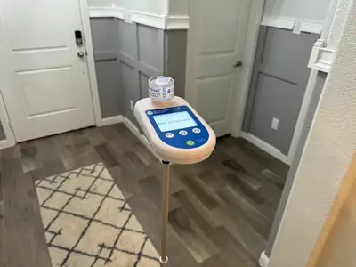 Air sampling device on a bathroom floor