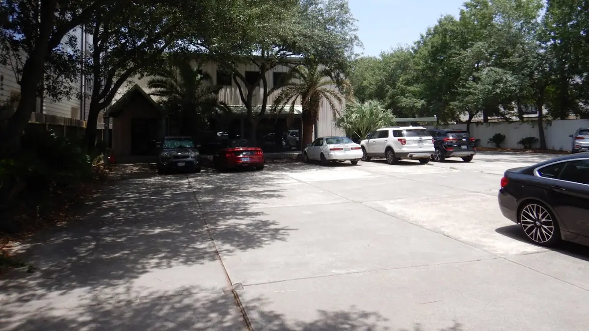 Tree-shaded parking area outside the Phase Engineering, LLC office