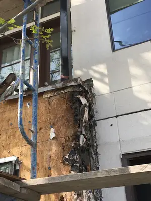 Exterior wall opened up to reveal damage
