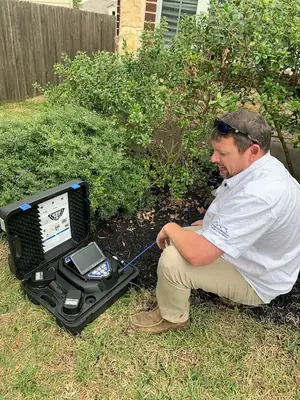 Inspector with an equipment case in a yard