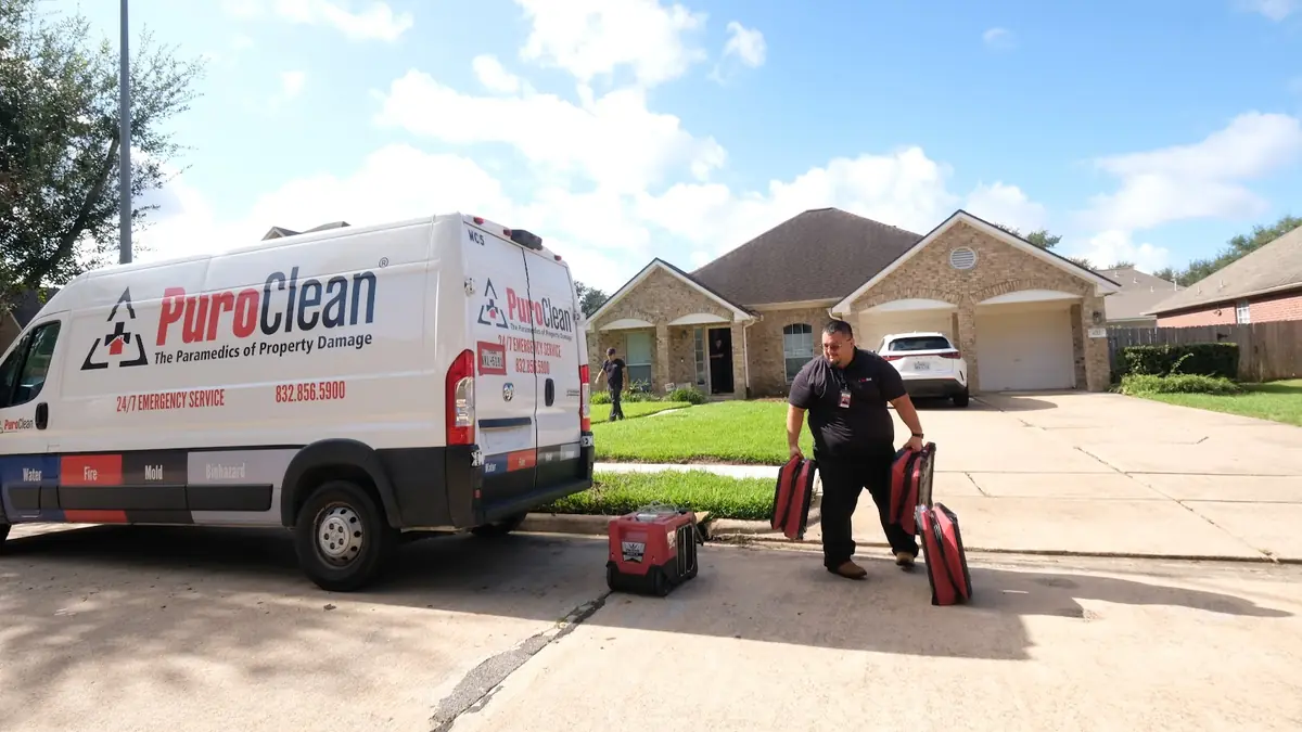 PuroClean van and technician outside a home
