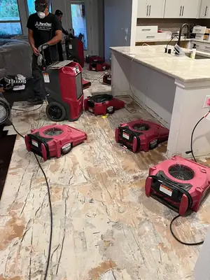 Air movers drying a floor
