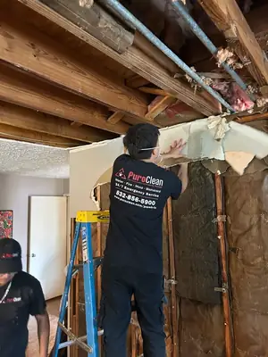 Technician stripping a damaged wall