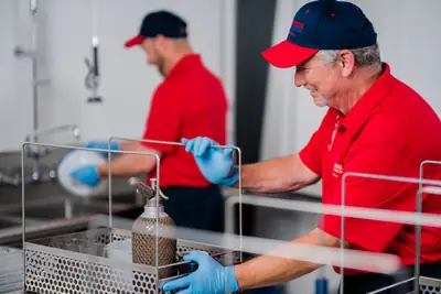Technicians cleaning in a kitchen