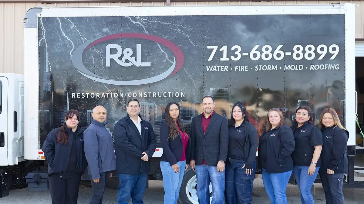 The R&L Restoration team in front of a branded box truck