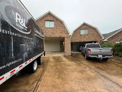 R&L Restoration truck outside a home