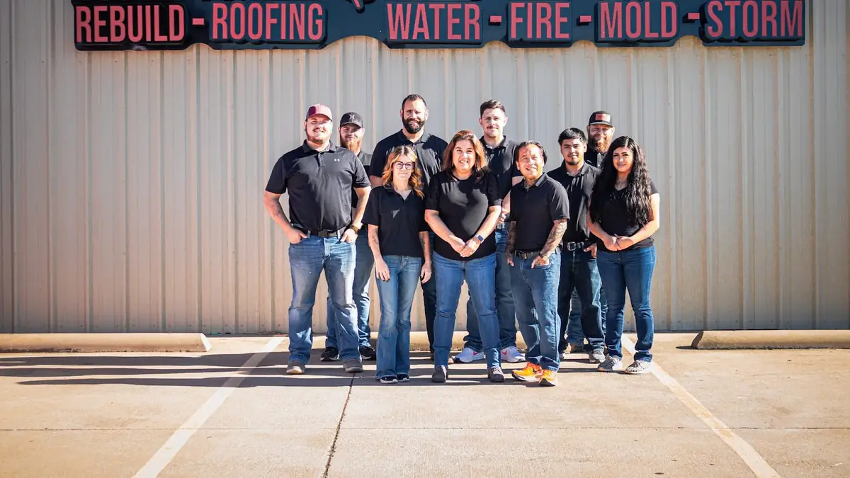 The Rapid Restoration Texas team in front of a company banner