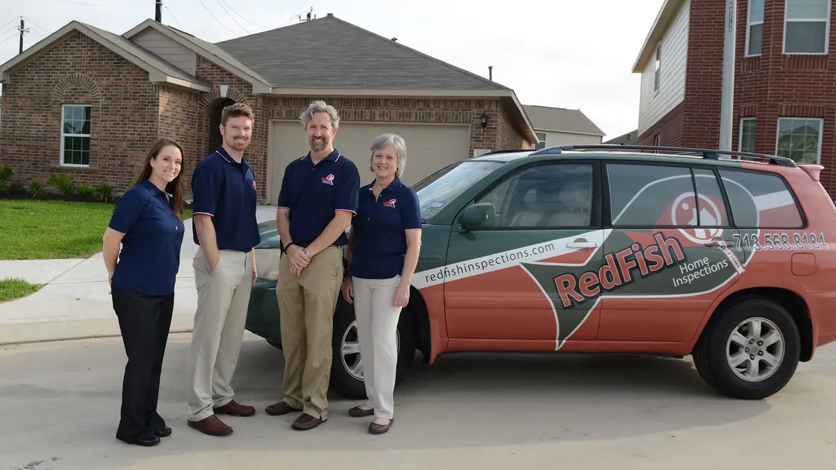 RedFish Inspections inspectors beside a branded vehicle