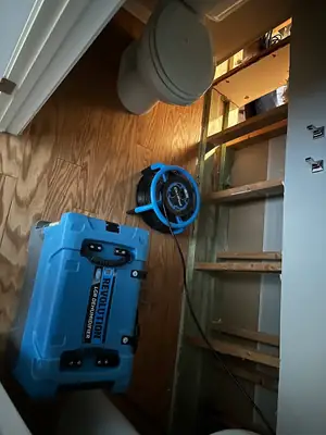 Air mover drying a wall