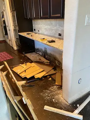 Cabinets removed with damage exposed